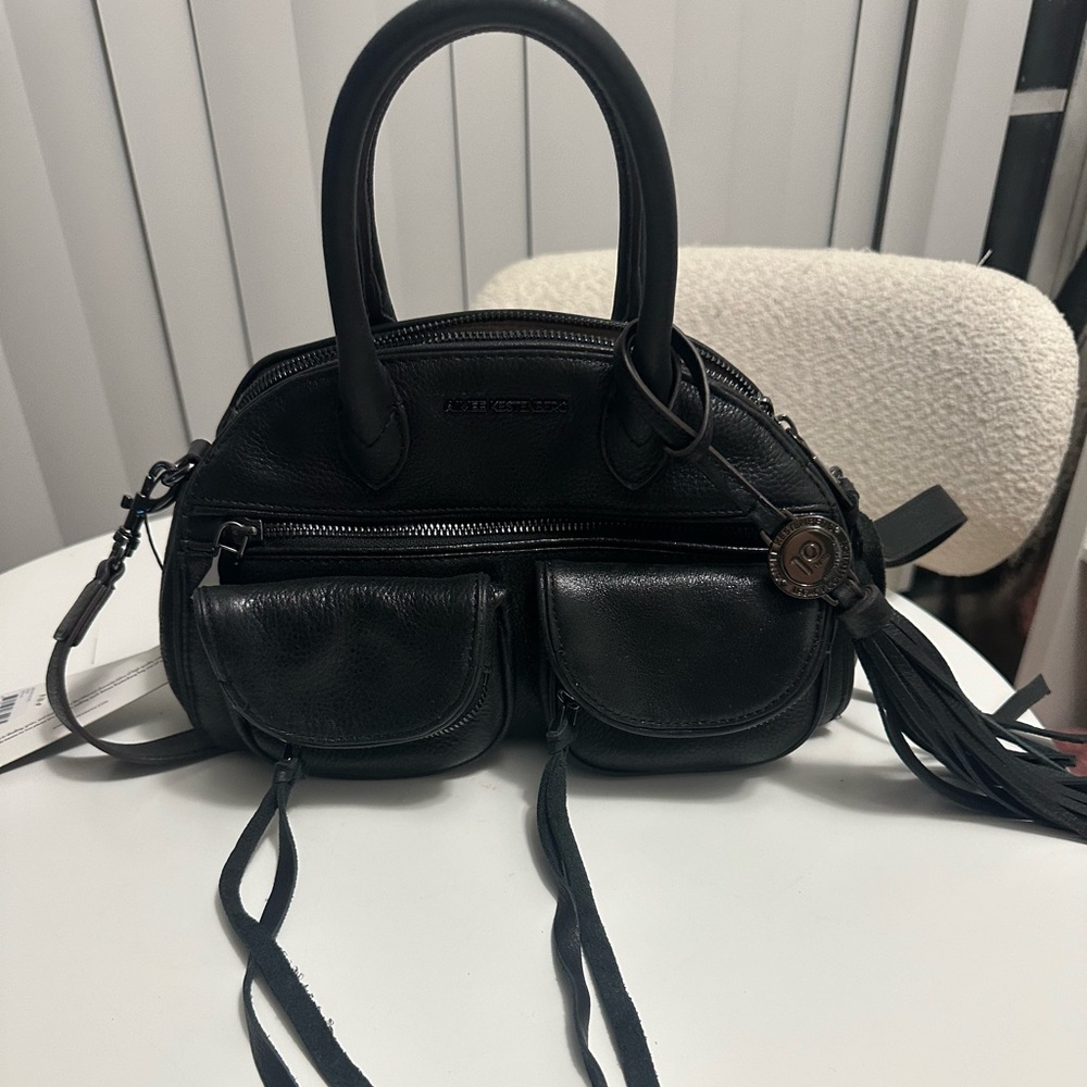Black small leather bag .